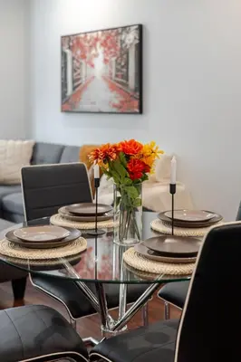 a dining room table with a vase of flowers on it at Central 1BDR Apartment on Bishop Central MTL in Montréal