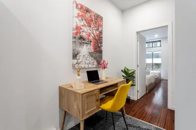 a home office with a desk and yellow chairs at Central 1BDR Apartment on Bishop Central MTL in Montréal