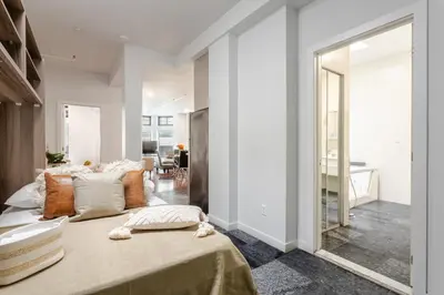 a bedroom with a large bed and a living room at Central 1BDR Apartment on Bishop Central MTL in Montréal