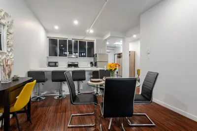 a kitchen and dining room with a table and chairs at Central 1BDR Apartment on Bishop Central MTL in Montréal