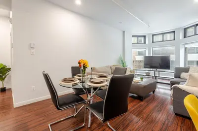 a living room with a table and chairs and a couch at Central 1BDR Apartment on Bishop Central MTL in Montréal