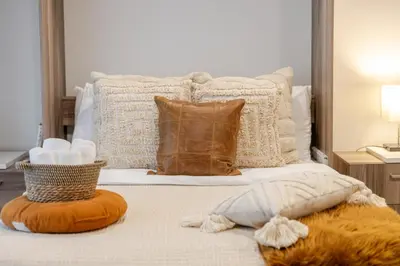 a bed with pillows and pillows on it at Spacious Studio on Bishop - Hot Spot Dtown MTL in Montréal