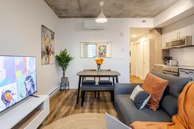 a living room with a couch and a table at Stylish 1BDR Apartment in the Heart of DT MTL in Montréal