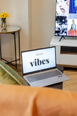 a laptop computer sitting on top of a table at Stylish 1BDR Apartment in the Heart of DT MTL in Montréal