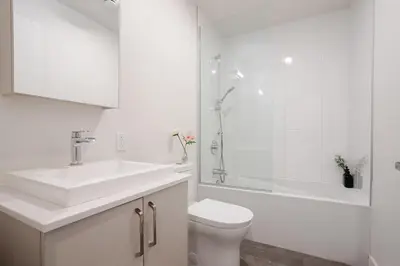 a bathroom with a sink and a toilet and a shower at Stylish 1BDR Apartment in the Heart of DT MTL in Montréal