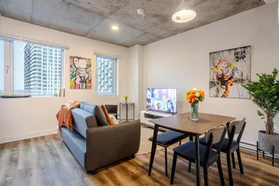 a living room with a couch and a table at Stylish 1BDR Apartment in the Heart of DT MTL in Montréal