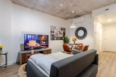 a living room with a couch and a tv at Cute 1BDR Apt in Ste-Catherine - MTL Live Spot in Montréal