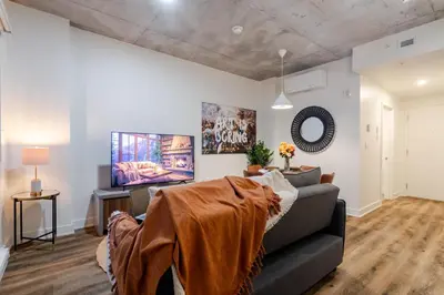 a living room with a couch and a tv at Cute 1BDR Apt in Ste-Catherine - MTL Live Spot in Montréal