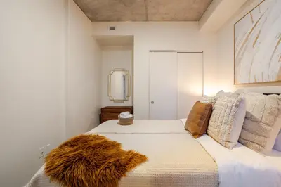 a bedroom with a bed with a furry blanket on it at Cute 1BDR Apt in Ste-Catherine - MTL Live Spot in Montréal