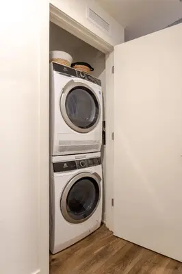 two microwaves stacked on top of each other in a closet at Cute 1BDR Apt in Ste-Catherine - MTL Live Spot in Montréal