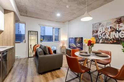 a living room with a table and chairs at Cute 1BDR Apt in Ste-Catherine - MTL Live Spot in Montréal