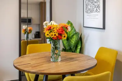 a vase of flowers sitting on a wooden table at Modern 1BR in downtown in Montréal