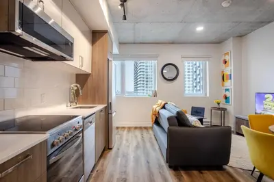 a kitchen with a couch in the middle of a room at Modern 1BR in downtown in Montréal