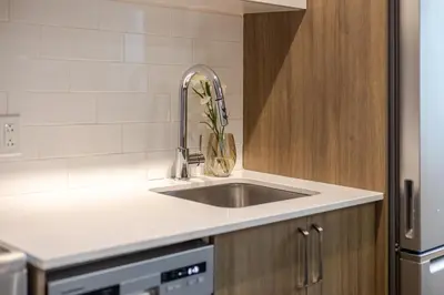 a kitchen sink with a vase with flowers in it at Modern 1BR in downtown in Montréal