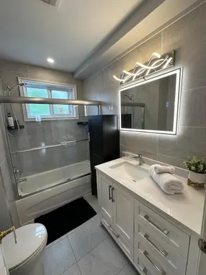 a bathroom with a sink and a shower and a toilet at Luxieux Appartement laval in Laval