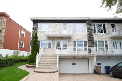 a large house with stairs and a garage at Luxieux Appartement laval in Laval