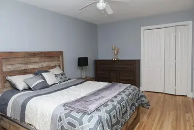 a bedroom with a large bed and a ceiling fan at Luxieux Appartement laval in Laval