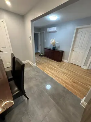 a living room with a chair and a table at Luxieux Appartement laval in Laval