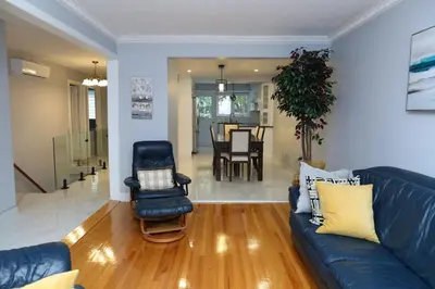 a living room with a blue couch and a chair at Appartement 3 chambres avec SOUS-SOL in Laval