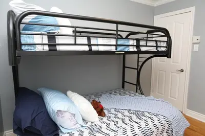 a bedroom with a bunk bed with a teddy bear on it at Appartement 3 chambres avec SOUS-SOL in Laval