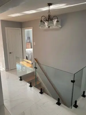 a room with a staircase and a glass table at Appartement 3 chambres avec SOUS-SOL in Laval