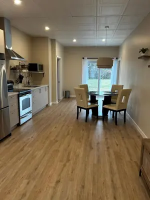 a kitchen and dining room with a table and chairs at Comme chez soi in Granby