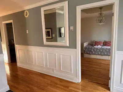 a room with a mirror and a bed in it at Vieux Beloeil appartement free Parking in Beloeil Village