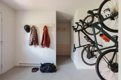 a bike hanging on a wall in a room at Chalets OST Shefford FORFAIT GROUPE in Shefford