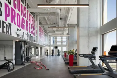a gym with treadmills and exercise equipment in a building at Moxy Montreal Downtown in Montréal