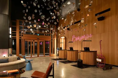a lobby with a bunch of glasses on the wall at Moxy Montreal Downtown in Montréal