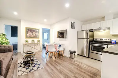 a kitchen and living room with a table and chairs at Bright stay in Griffin Town in Montréal