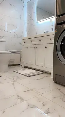 a white bathroom with a sink and a washing machine at Cozy Terrebonne in Terrebonne