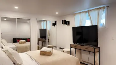 a bedroom with a flat screen tv and a bed at Cozy Terrebonne in Terrebonne