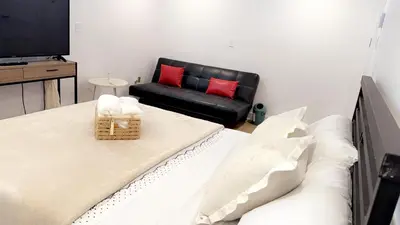 a living room with a bed and a couch at Cozy Terrebonne in Terrebonne