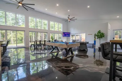 a living room with a ping pong table in it at L'Étoile Brillante, Spa, River, Pool Table in La Patrie
