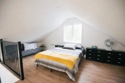 a bedroom with a bed and a window at Chalet Escapade, Spa, Piscine in La Patrie