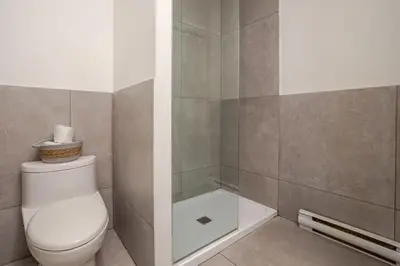a bathroom with a toilet and a shower at Cute Studio on Bishop - Hot Spot Dtown MTL in Montréal
