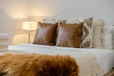 a bed with pillows and a dog laying on it at Cute Studio on Bishop - Hot Spot Dtown MTL in Montréal
