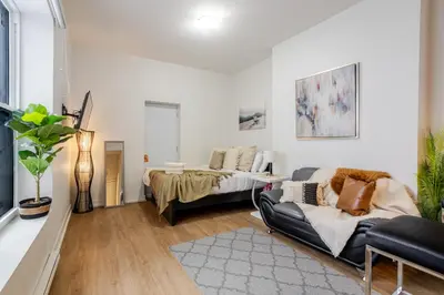 a living room with a couch and a table at Snug Studio on Bishop DT MTL in Montréal