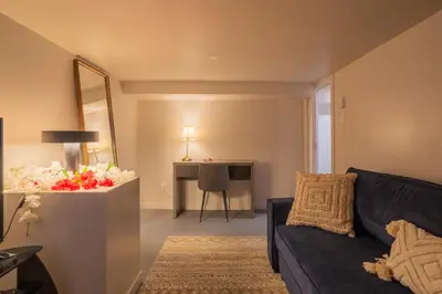 a living room with a black couch and a table at Stylish 4BR in the heart of Plateau Montreal in Montréal