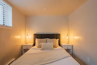 a bedroom with a bed with two night stands at Stylish 4BR in the heart of Plateau Montreal in Montréal
