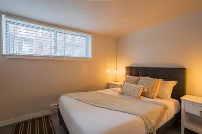 a bedroom with a large bed and a window at Stylish 4BR in the heart of Plateau Montreal in Montréal