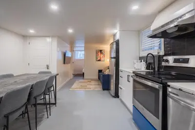 a kitchen with a counter top and a table and chairs at Stylish 4BR in the heart of Plateau Montreal in Montréal