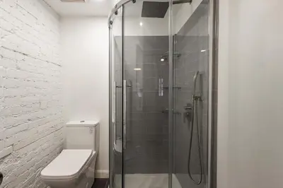 a bathroom with a toilet and a glass shower at Au coeur du plateau!! in Montréal