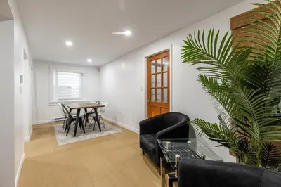 a living room with a table and a plant at Au coeur du plateau!! in Montréal