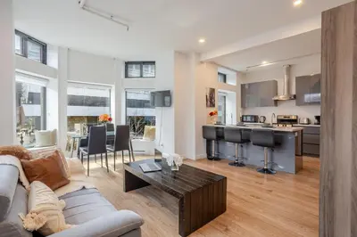 a living room with a couch and a table at Inner-City Studio on Bishop -Heart of MTL in Montréal