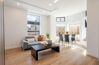 a living room with a couch and a table at Inner-City Studio on Bishop -Heart of MTL in Montréal