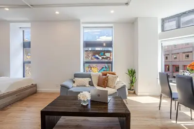 a living room with a couch and a table at Inner-City Studio on Bishop -Heart of MTL in Montréal
