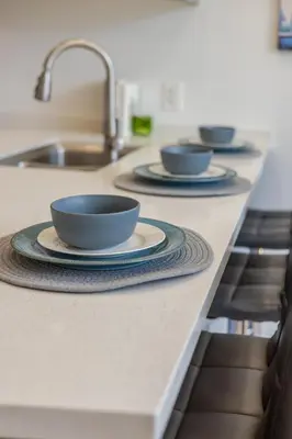 a kitchen counter with three bowls on a counter top at Cute 1BDR Apt on Bishop St- Heart of MTL in Montréal