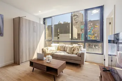 a living room with a couch and a table at Cute 1BDR Apt on Bishop St- Heart of MTL in Montréal